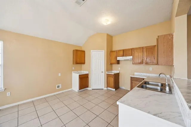 a spacious bedroom with a bed and furniture