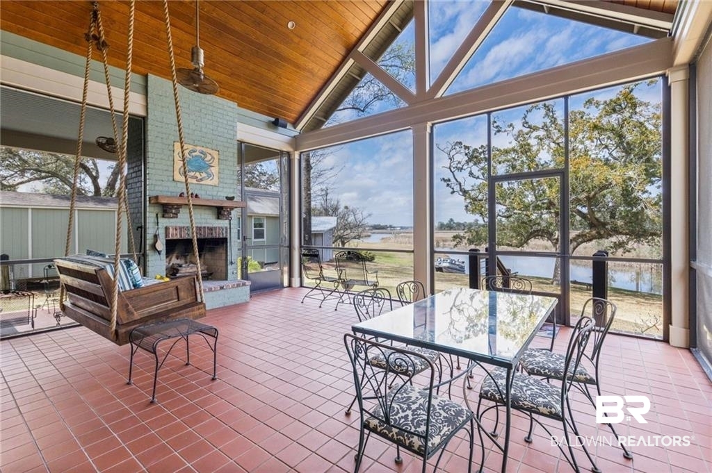 2730 Gator Road Mobile, AL 36605 - Photo 5 of 42 Sunroom featuring a water view, tile patterned floors, and a high wooden ceiling