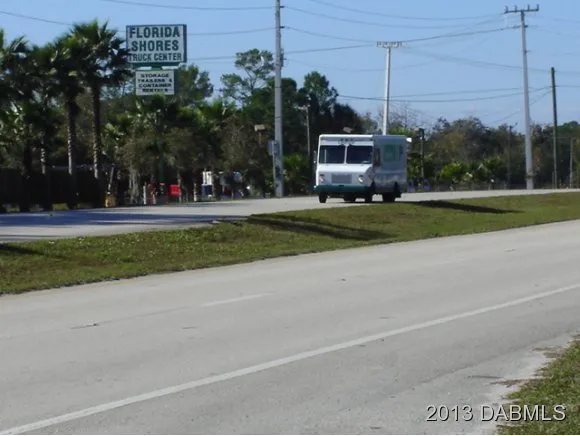 a view of a field with trees in the background