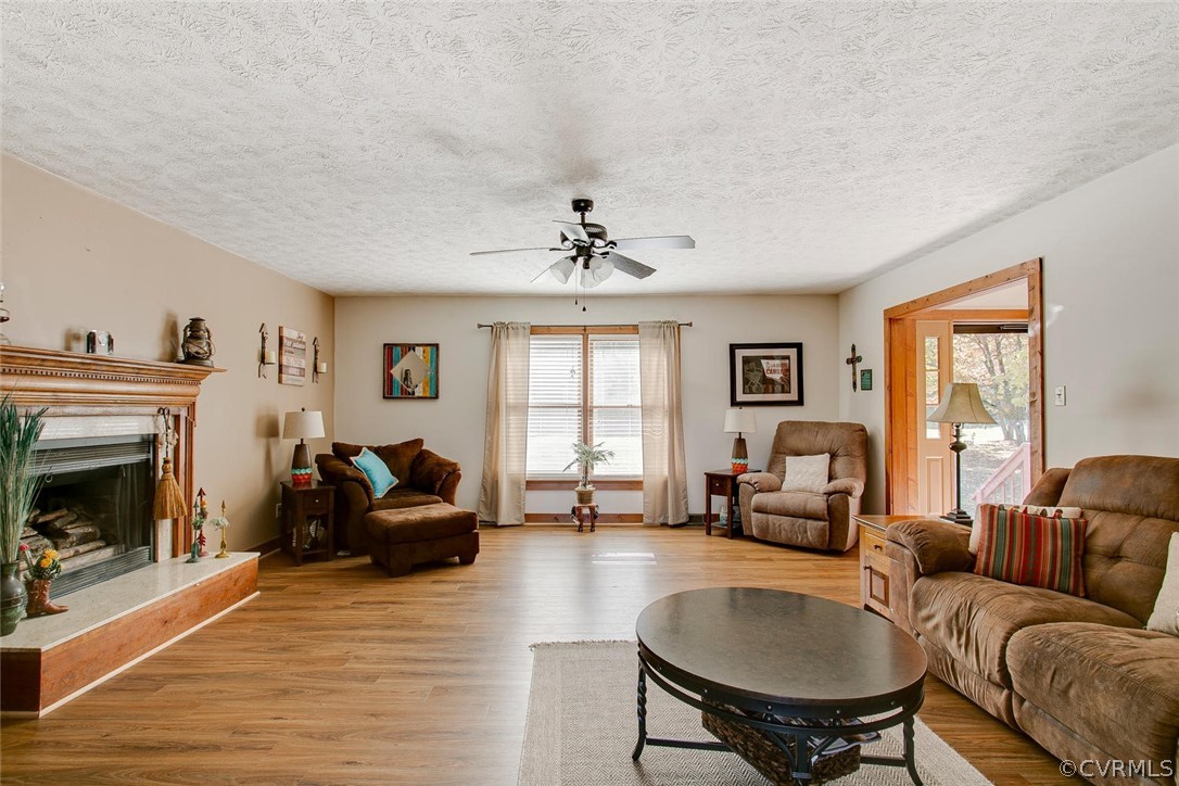 13200 Beach Road Chesterfield, VA 23832 - Photo 6 of 30 a living room with furniture a fireplace and a table