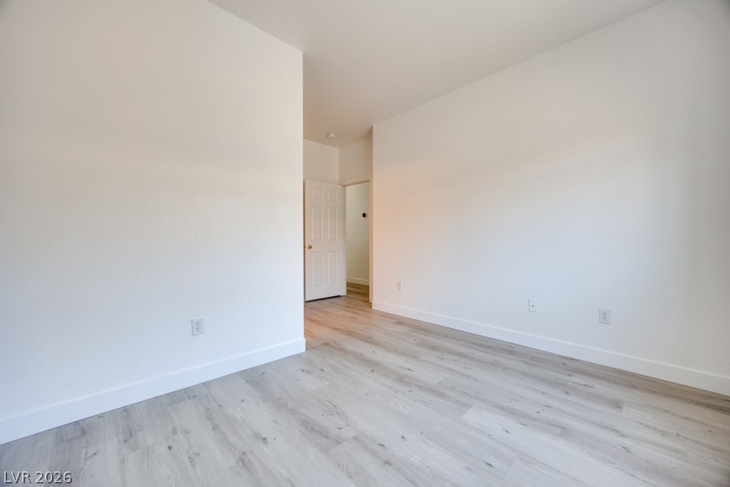 4915 East Russell Road, Unit 127 Las Vegas, NV 89120 - Photo 12 of 19 Newly installed hardwood flooring and fresh white walls create a pristine and adaptable living space.