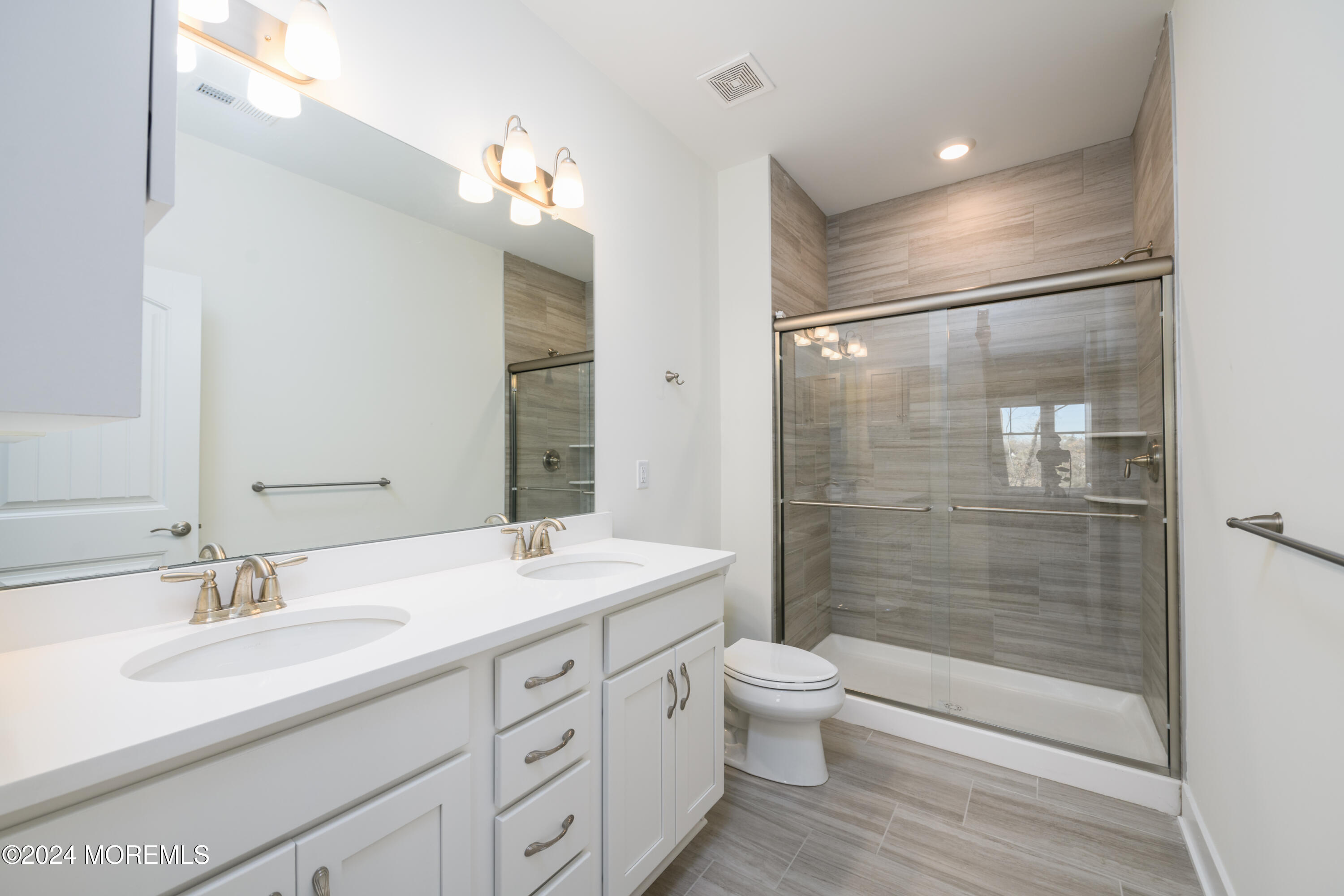 17 Raritan Cove Keyport, NJ 07735 - Photo 15 of 42 a bathroom with a double vanity sink toilet and shower