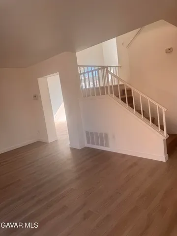 a view of an entryway with wooden floor