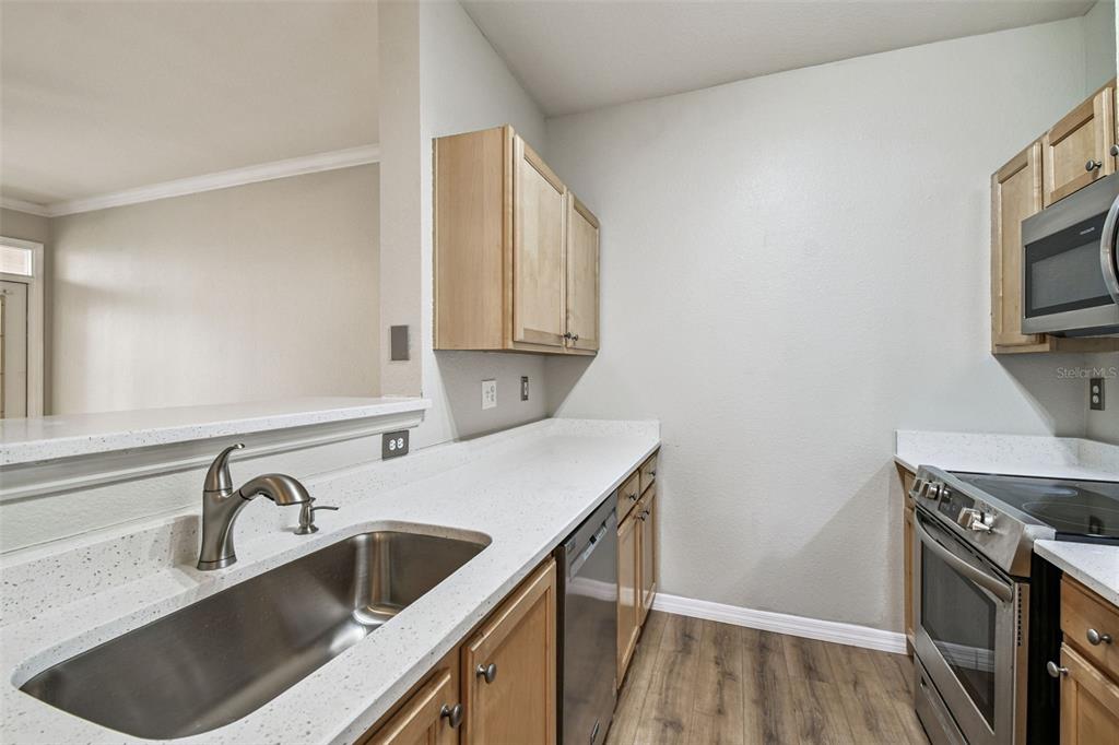 5000 Culbreath Key Way, Unit 1215 Tampa, FL 33611 - Photo 11 of 57 a kitchen with a sink cabinets and a stove