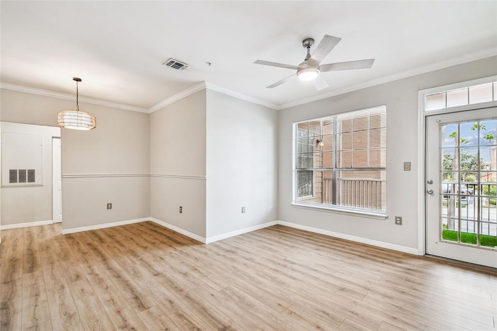 5000 Culbreath Key Way, Unit 1215 Tampa, FL 33611 - Photo 14 of 57 a view of empty room with wooden floor and fan