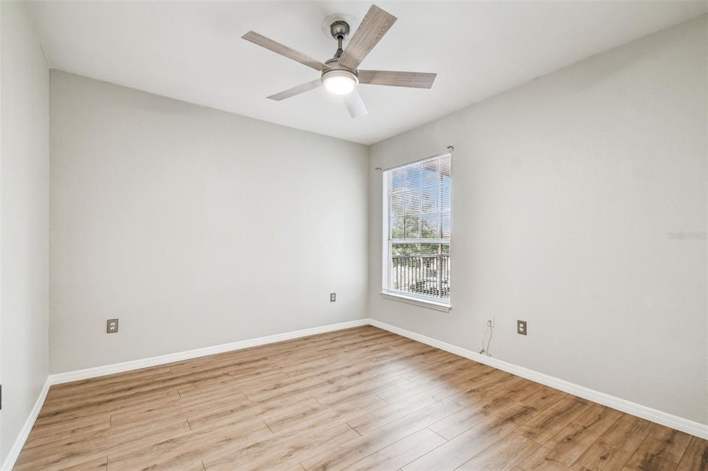 5000 Culbreath Key Way, Unit 1215 Tampa, FL 33611 - Photo 19 of 57 an empty room with wooden floor and windows