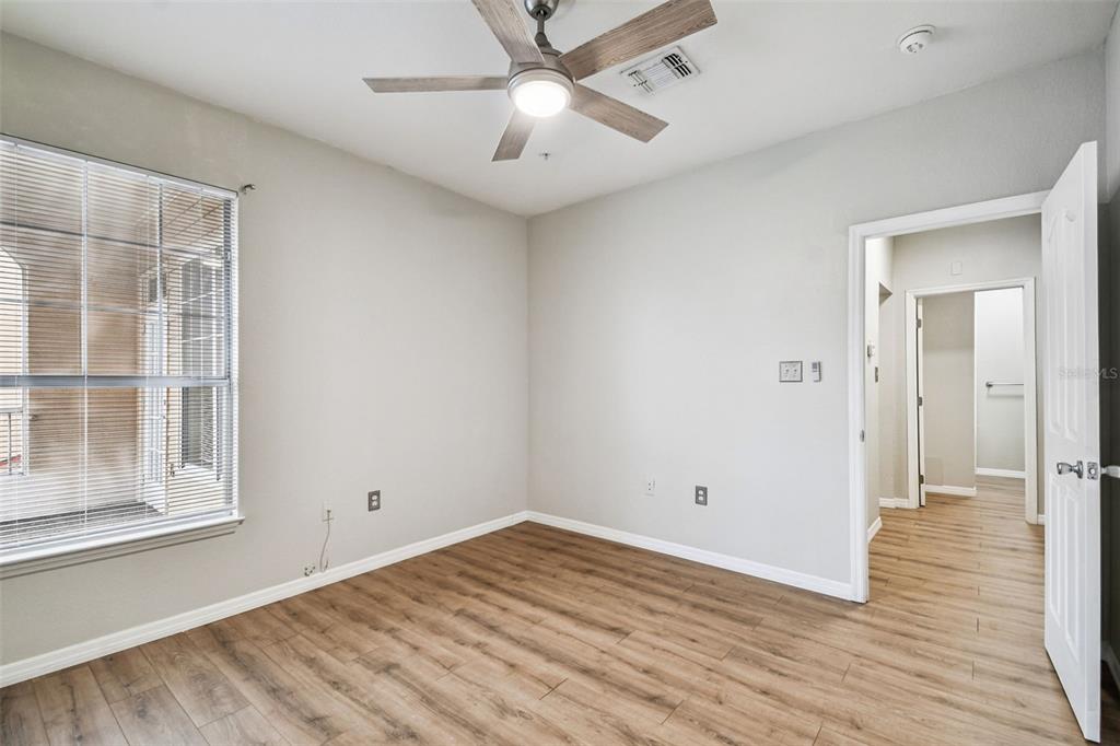 5000 Culbreath Key Way, Unit 1215 Tampa, FL 33611 - Photo 20 of 57 a view of empty room with wooden floor and fan