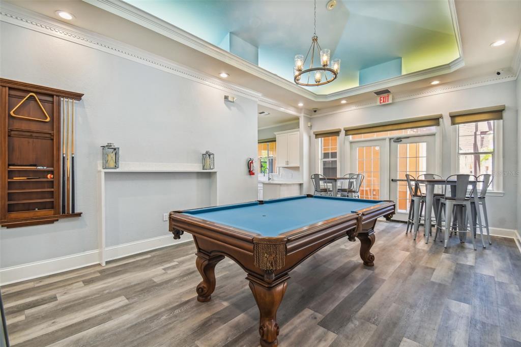 5000 Culbreath Key Way, Unit 1215 Tampa, FL 33611 - Photo 43 of 57 a room with wooden floors table tennis table and windows