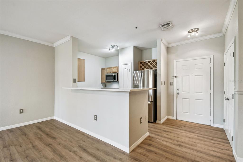 5000 Culbreath Key Way, Unit 1215 Tampa, FL 33611 - Photo 8 of 57 a view of a kitchen with wooden floor and a refrigerator
