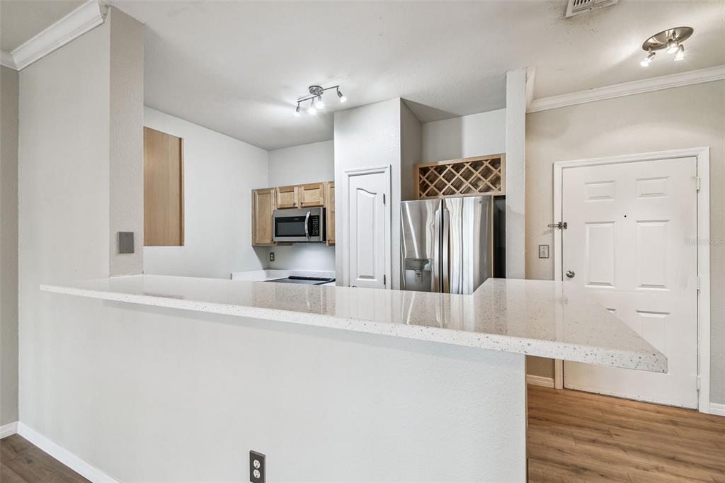 5000 Culbreath Key Way, Unit 1215 Tampa, FL 33611 - Photo 9 of 57 a kitchen with stainless steel appliances a refrigerator and microwave