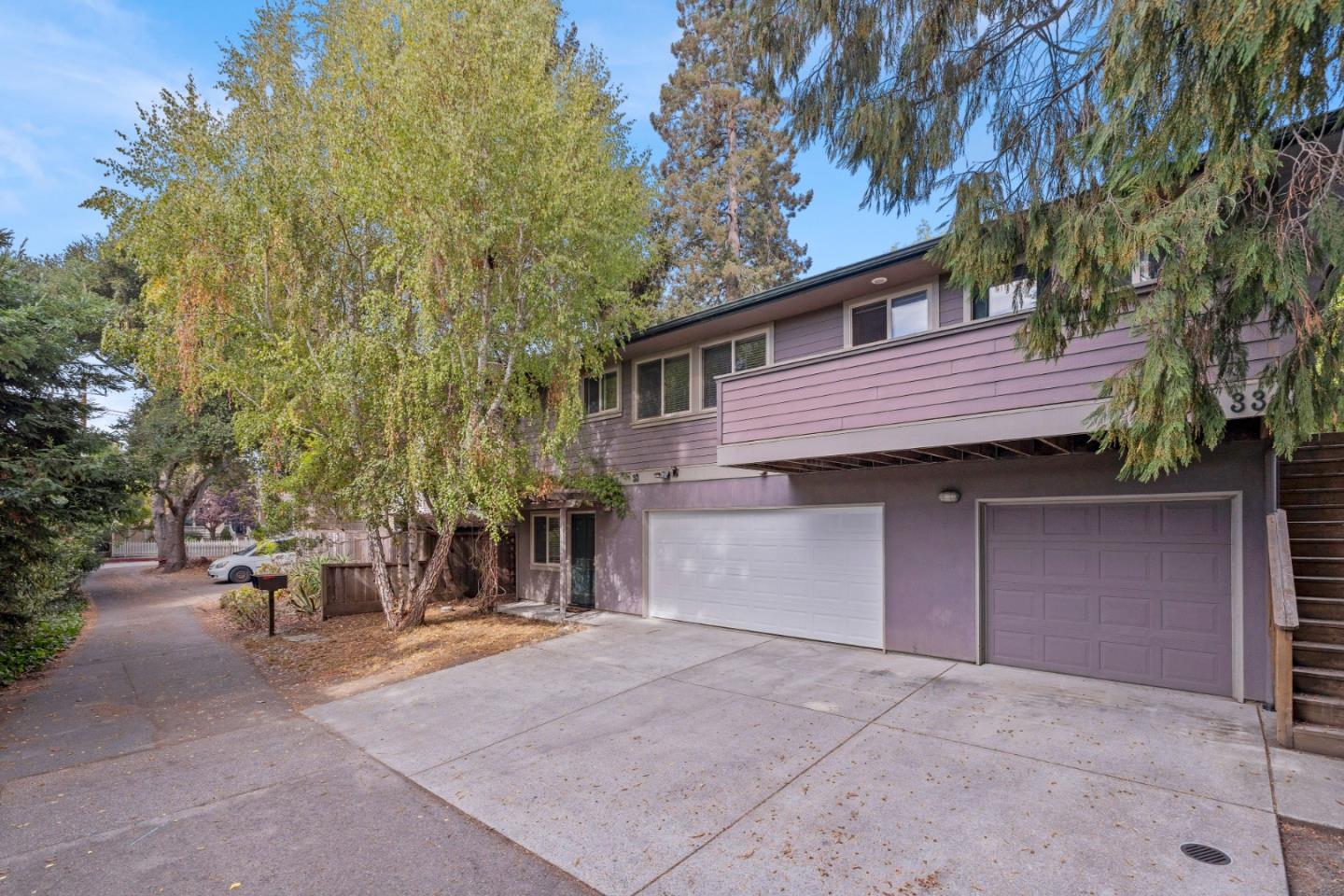 a view of a house with a patio and a yard