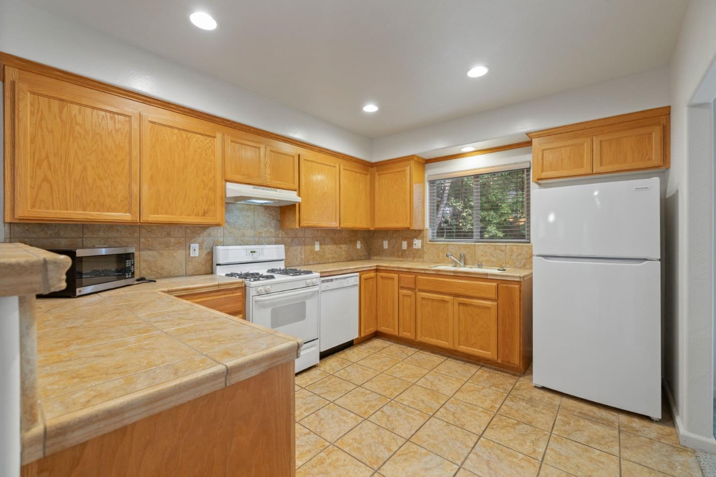 33 Edgewood Way Santa Cruz, CA 95060 - Photo 12 of 37 a kitchen with a refrigerator sink and cabinets