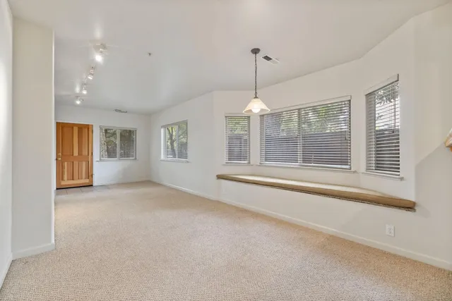 a view of an empty room with windows