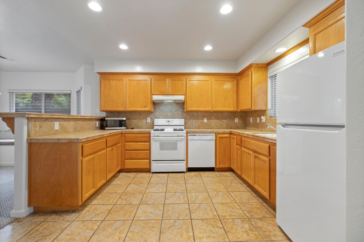 33 Edgewood Way Santa Cruz, CA 95060 - Photo 14 of 37 a kitchen with a sink window and white stainless steel appliances