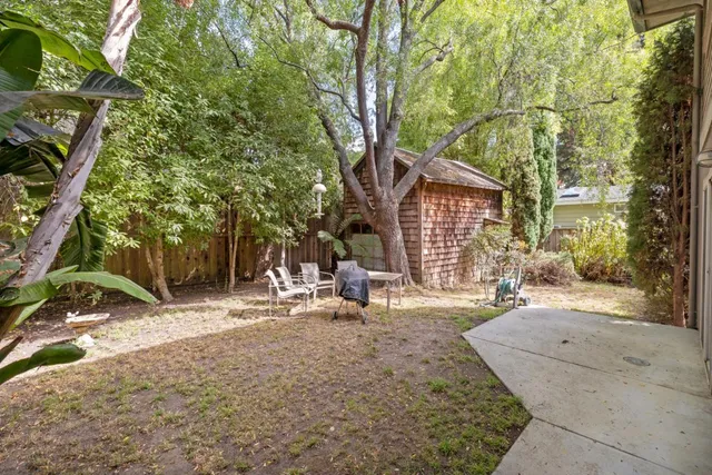 a backyard of a house with yard and outdoor seating