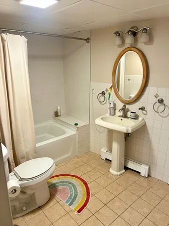 a bathroom with a toilet a sink and a bathtub