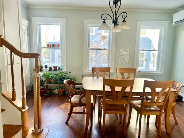 a view of a dining room with furniture window and wooden floor