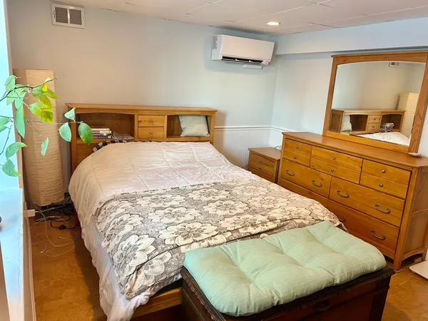 a bedroom with a bed and dresser