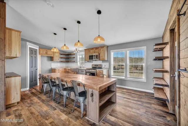 a view of a livingroom with furniture wooden floor and windows