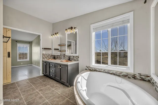 a bathroom with a double vanity sink a mirror and a shower