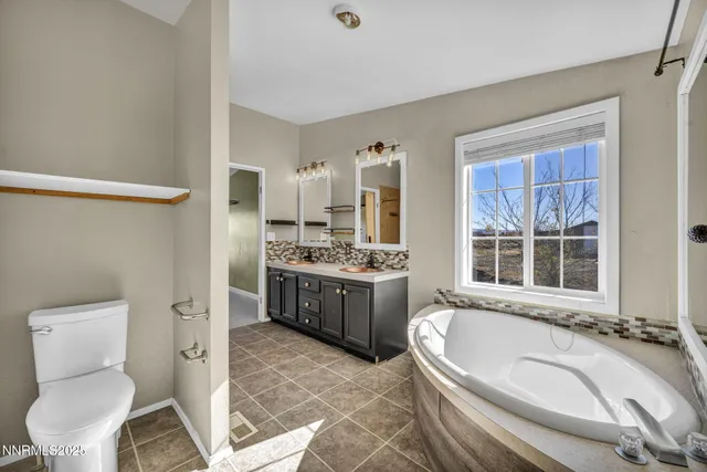 a kitchen with granite countertop white cabinets and refrigerator