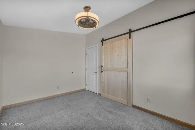 a bathroom with a granite countertop sink a toilet a mirror and shower