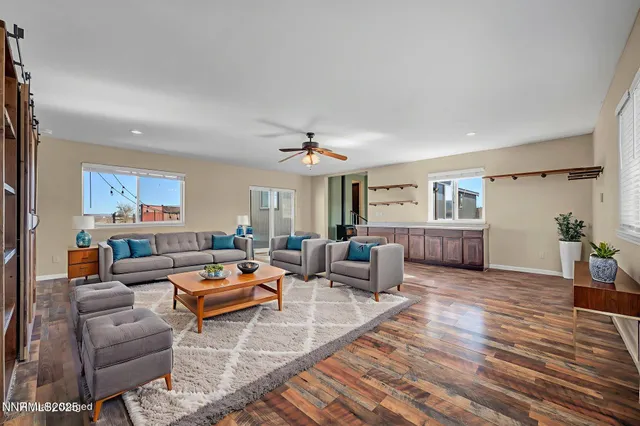 a very nice looking room with a large window and a wooden floor