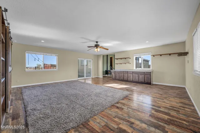 a view of hallway with closet and wooden floor