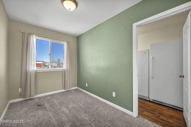 a view of a house with backyard and wooden fence