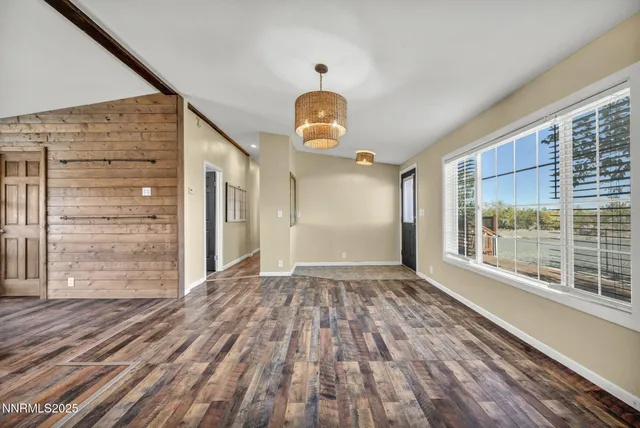 a living room with furniture a table and a chandelier