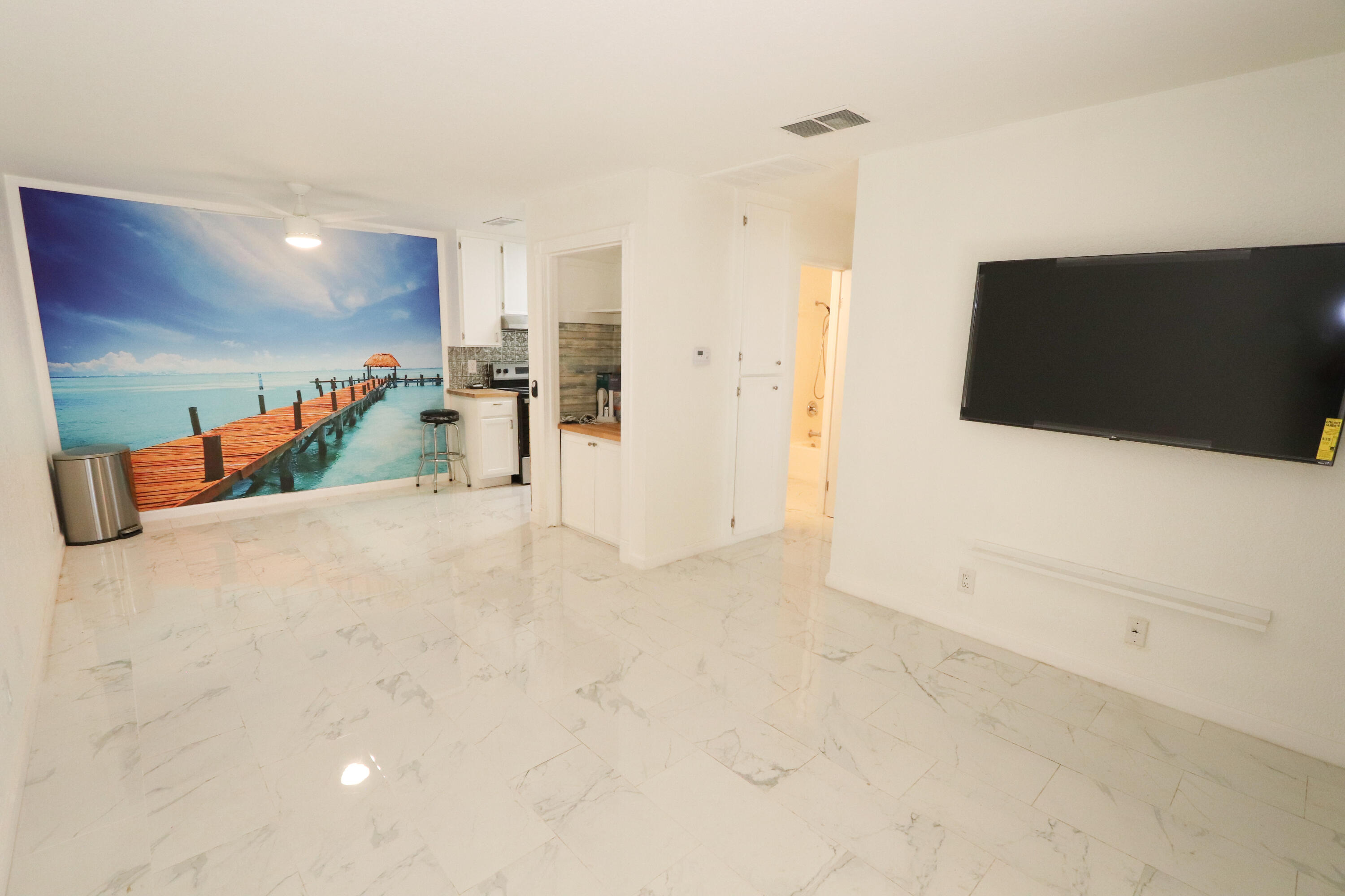 751 Los Felices Circle West, Unit 109 Palm Springs, CA 92262 - Photo 3 of 8 a view of a livingroom with wooden floor