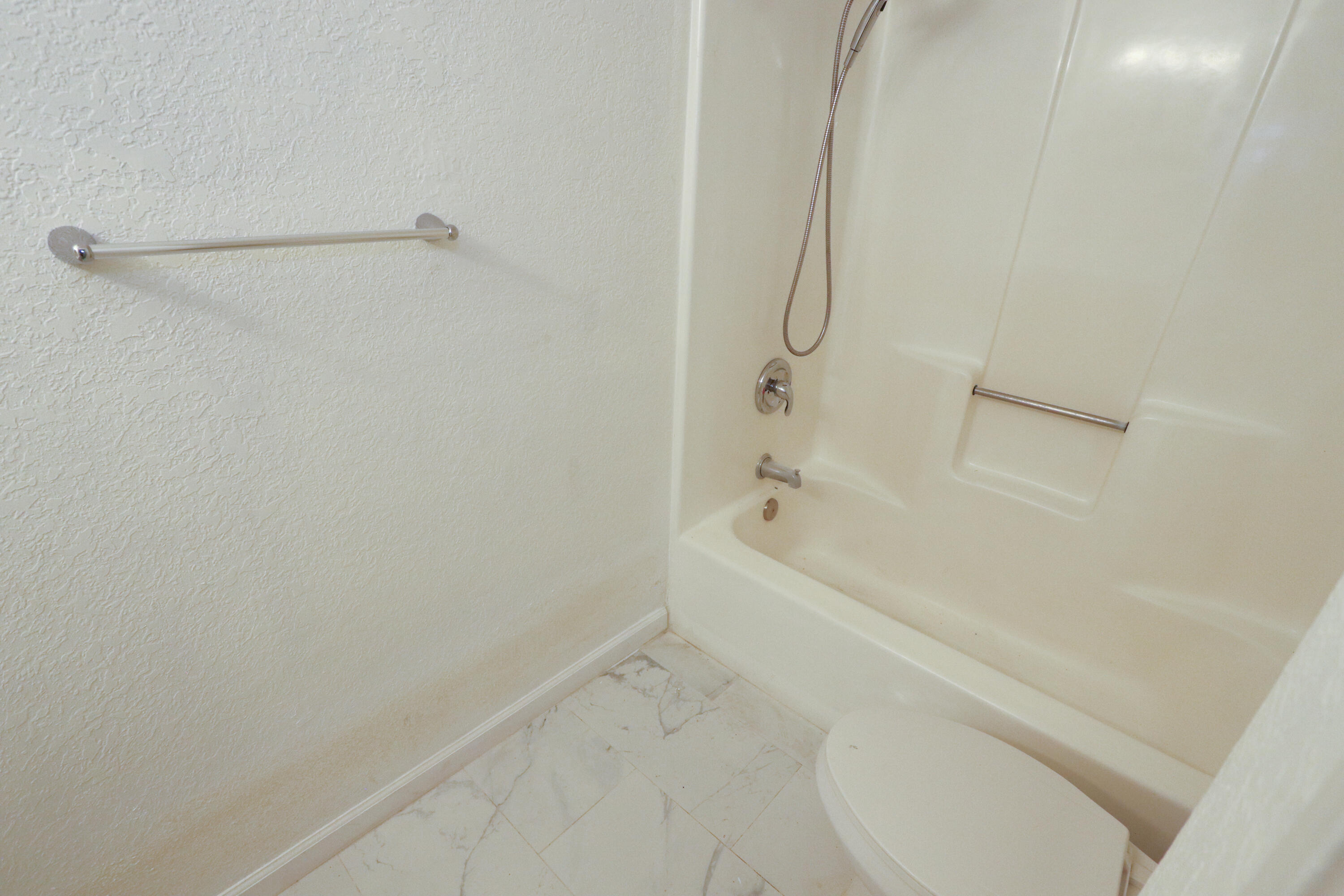 751 Los Felices Circle West, Unit 109 Palm Springs, CA 92262 - Photo 7 of 8 a bathroom with a bathtub and a shower