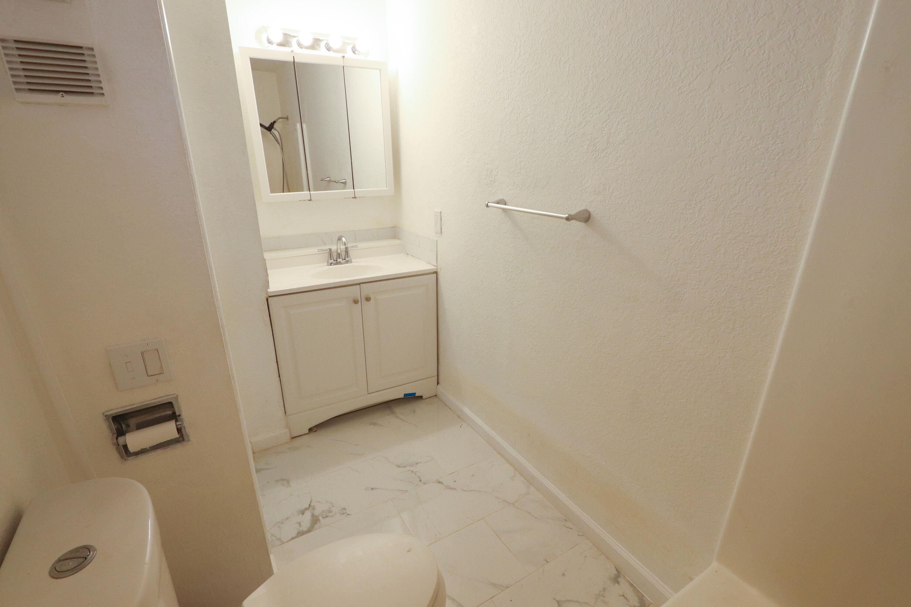 751 Los Felices Circle West, Unit 109 Palm Springs, CA 92262 - Photo 8 of 8 a bathroom with a sink and a mirror