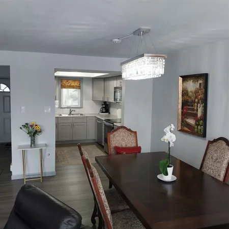 a living room with furniture and a chandelier