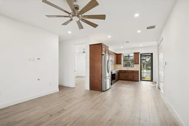 a kitchen with stainless steel appliances granite countertop a refrigerator stove and sink