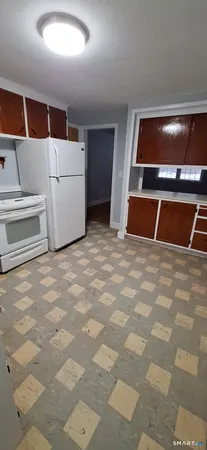 a view of a kitchen with microwave and refrigerator