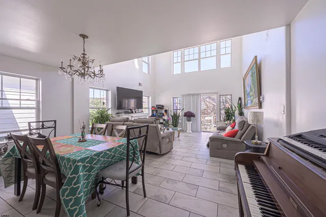 a dining room with furniture a chandelier and window
