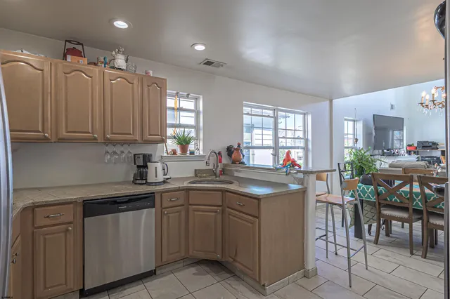 a kitchen with a sink window and cabinets