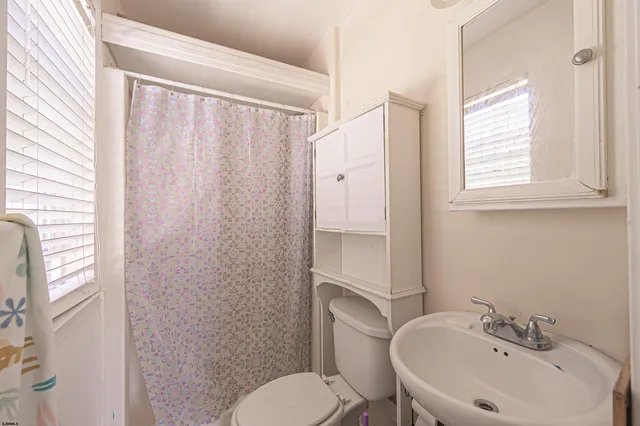 a view of hallway with stairs and wooden floor