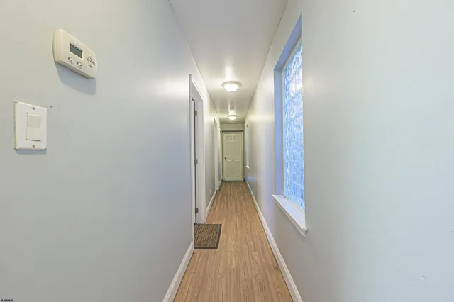 a utility room with wooden floor washer and dryer
