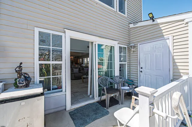 a view of a patio with table and chairs and potted plants