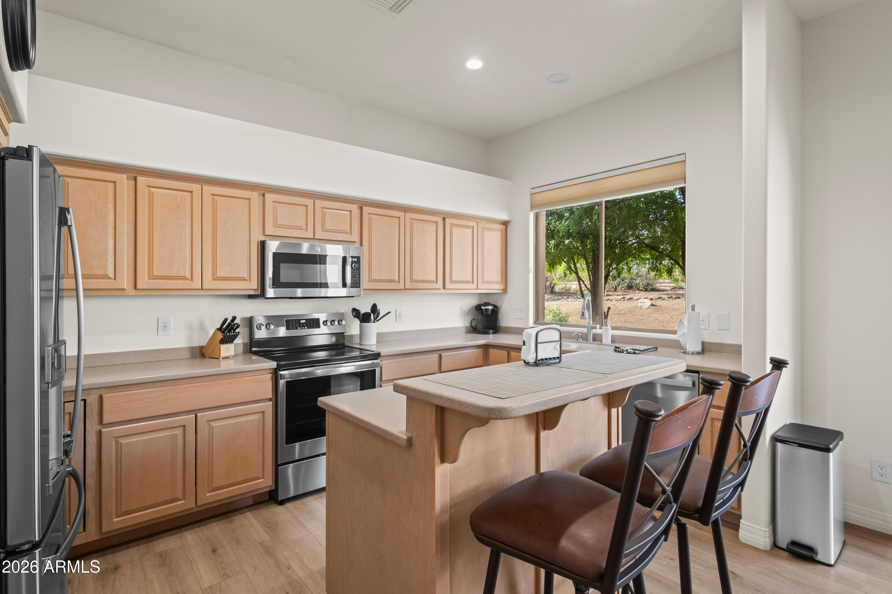 27504 North Montana Drive Rio Verde, AZ 85263 - Photo 14 of 32 a kitchen with a stove a sink a table and chairs