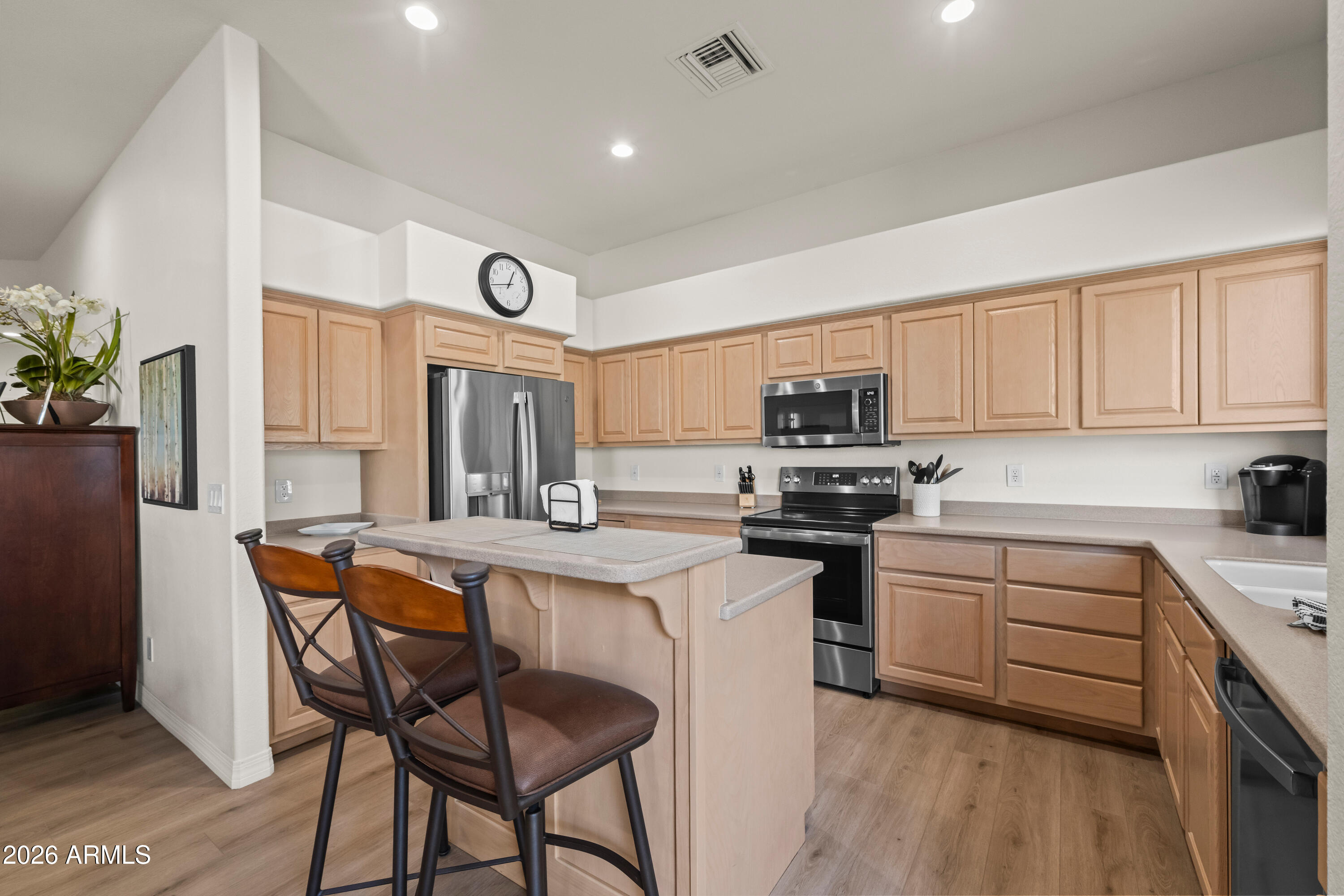 27504 North Montana Drive Rio Verde, AZ 85263 - Photo 15 of 32 a kitchen with stainless steel appliances granite countertop a stove a sink dishwasher and a refrigerator with wooden floor