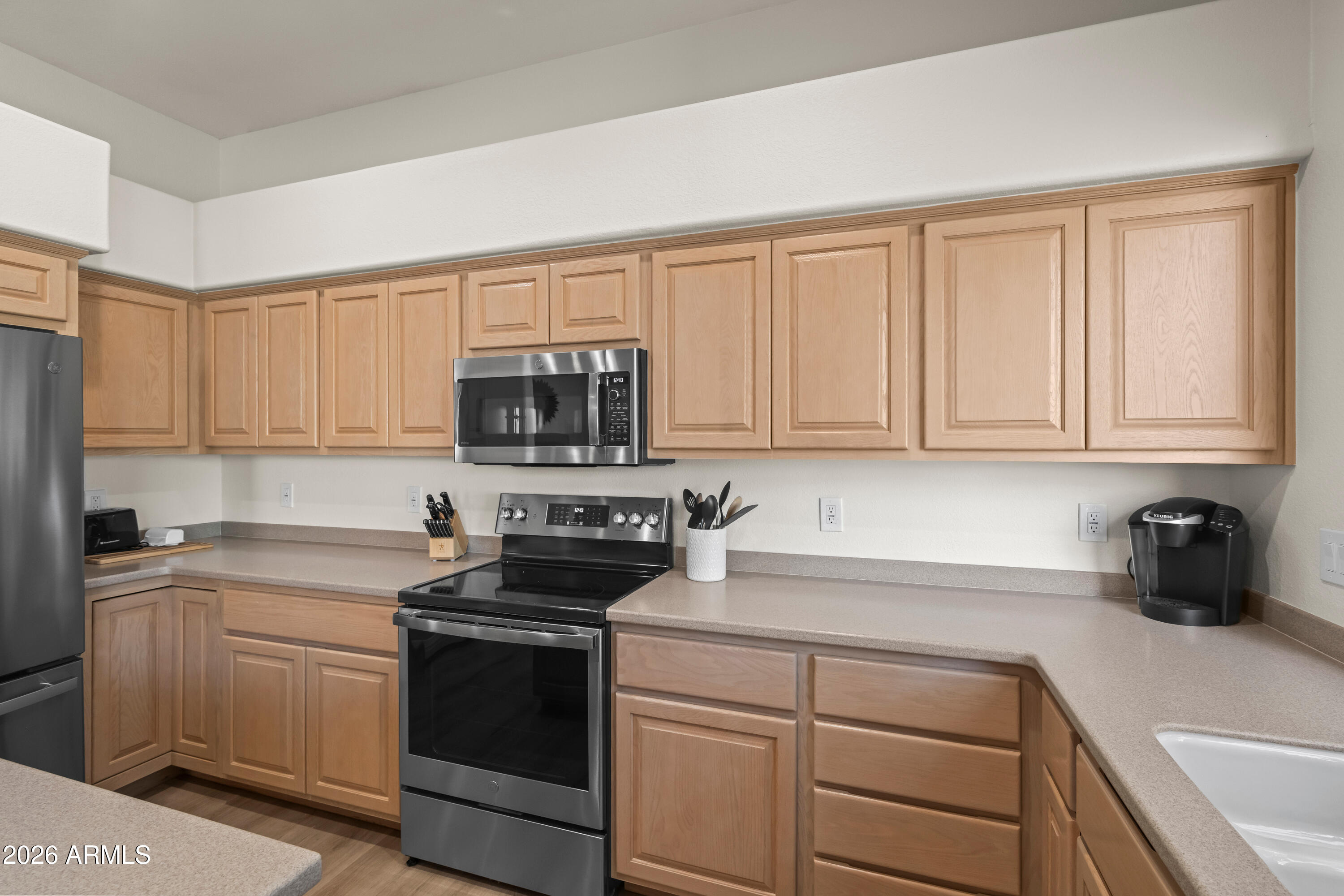 27504 North Montana Drive Rio Verde, AZ 85263 - Photo 17 of 32 a kitchen with white cabinets and white appliances
