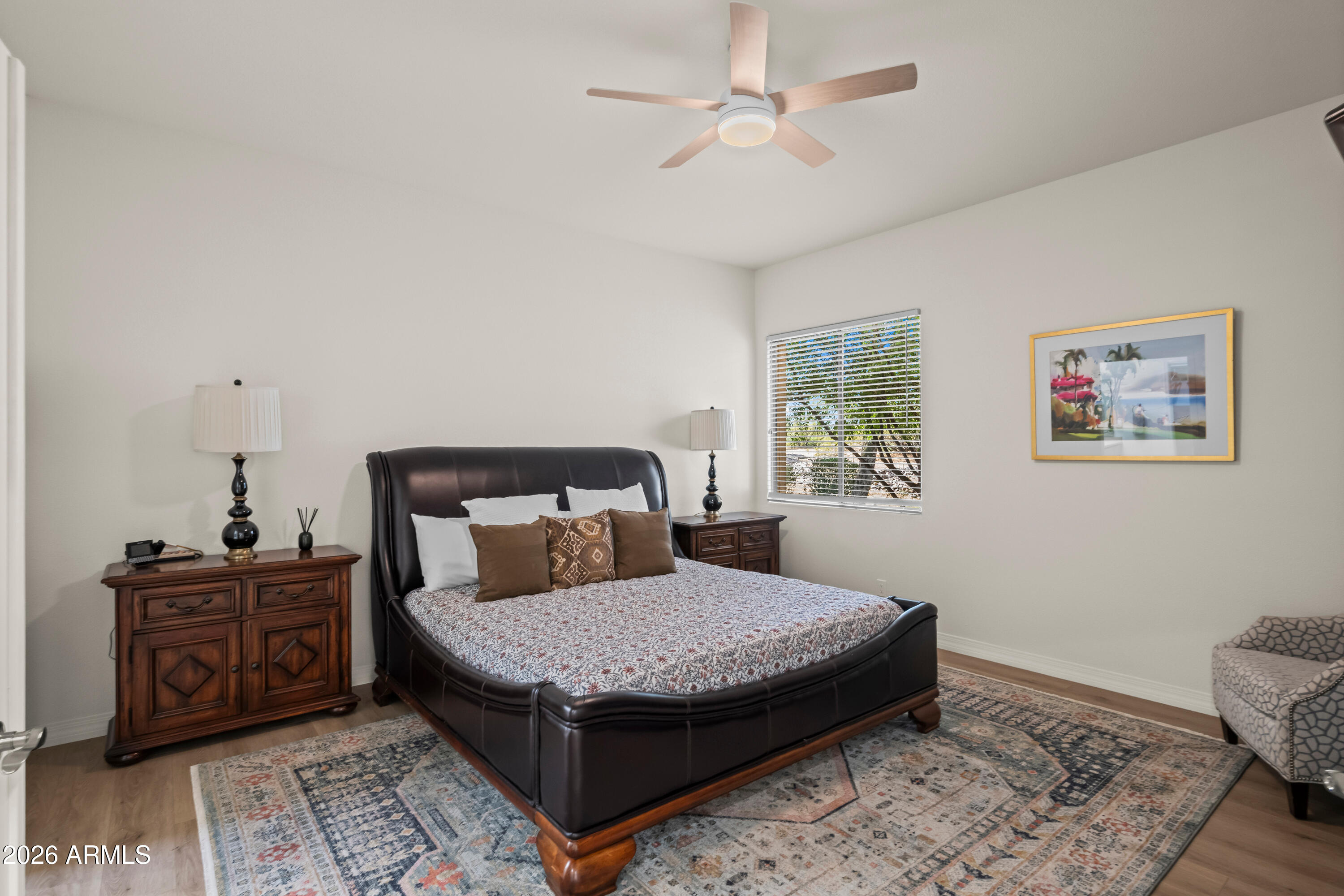 27504 North Montana Drive Rio Verde, AZ 85263 - Photo 19 of 32 a bedroom with a bed a dresser and wooden floor