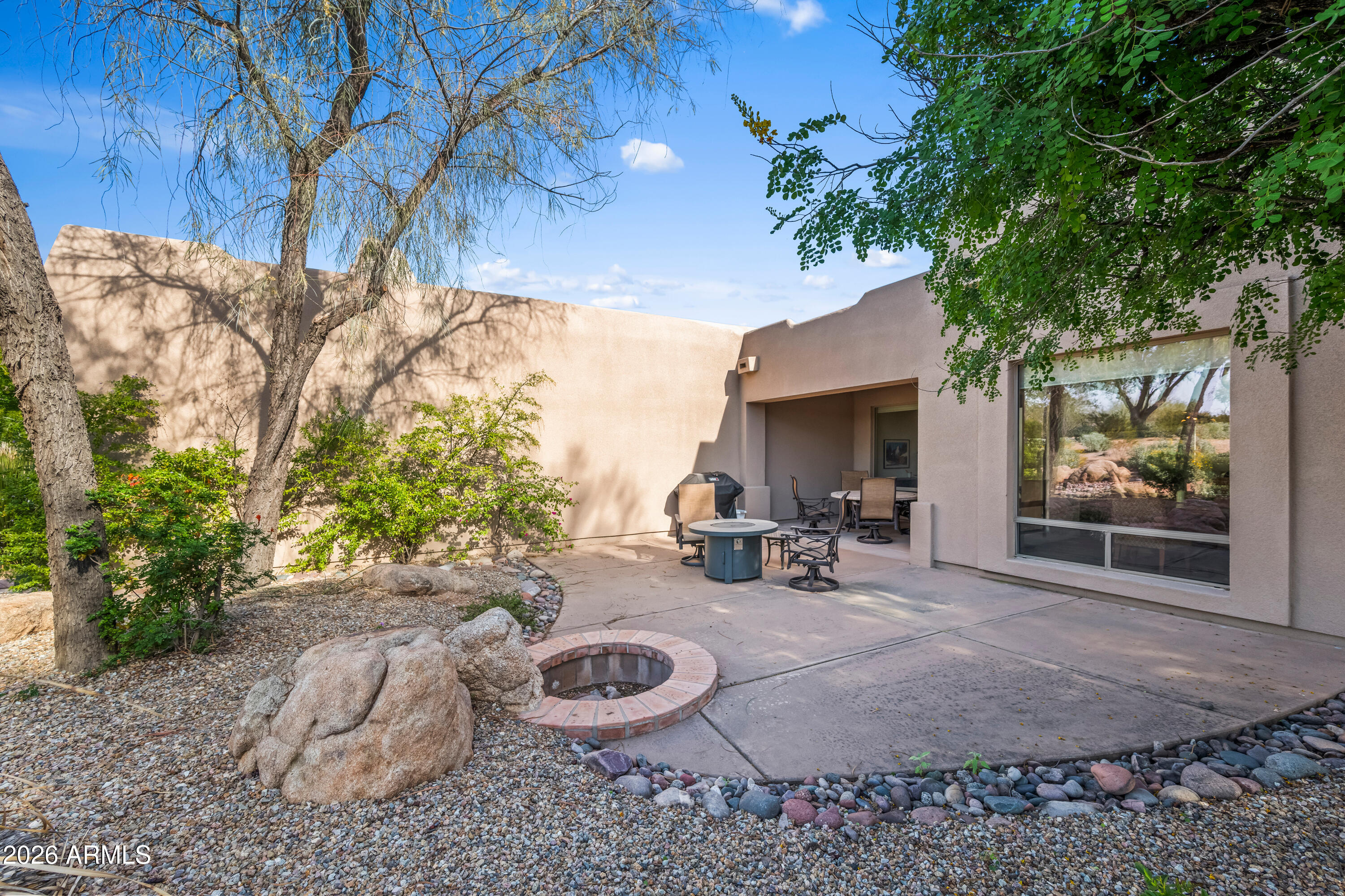 27504 North Montana Drive Rio Verde, AZ 85263 - Photo 29 of 32 a view of a backyard with table and chairs and a fire pit