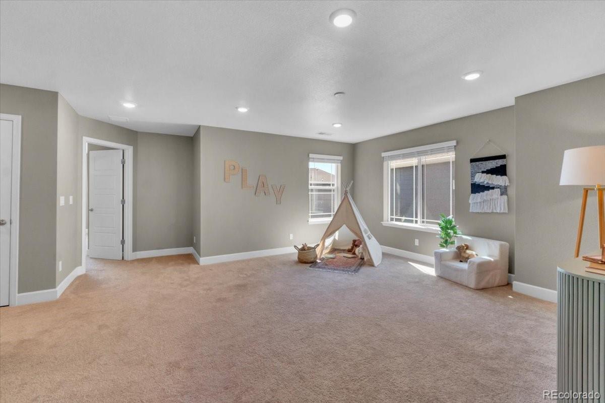 1721 Wingfeather Lane Castle Rock, CO 80108 - Photo 26 of 49 a view of room with wooden floor and windows
