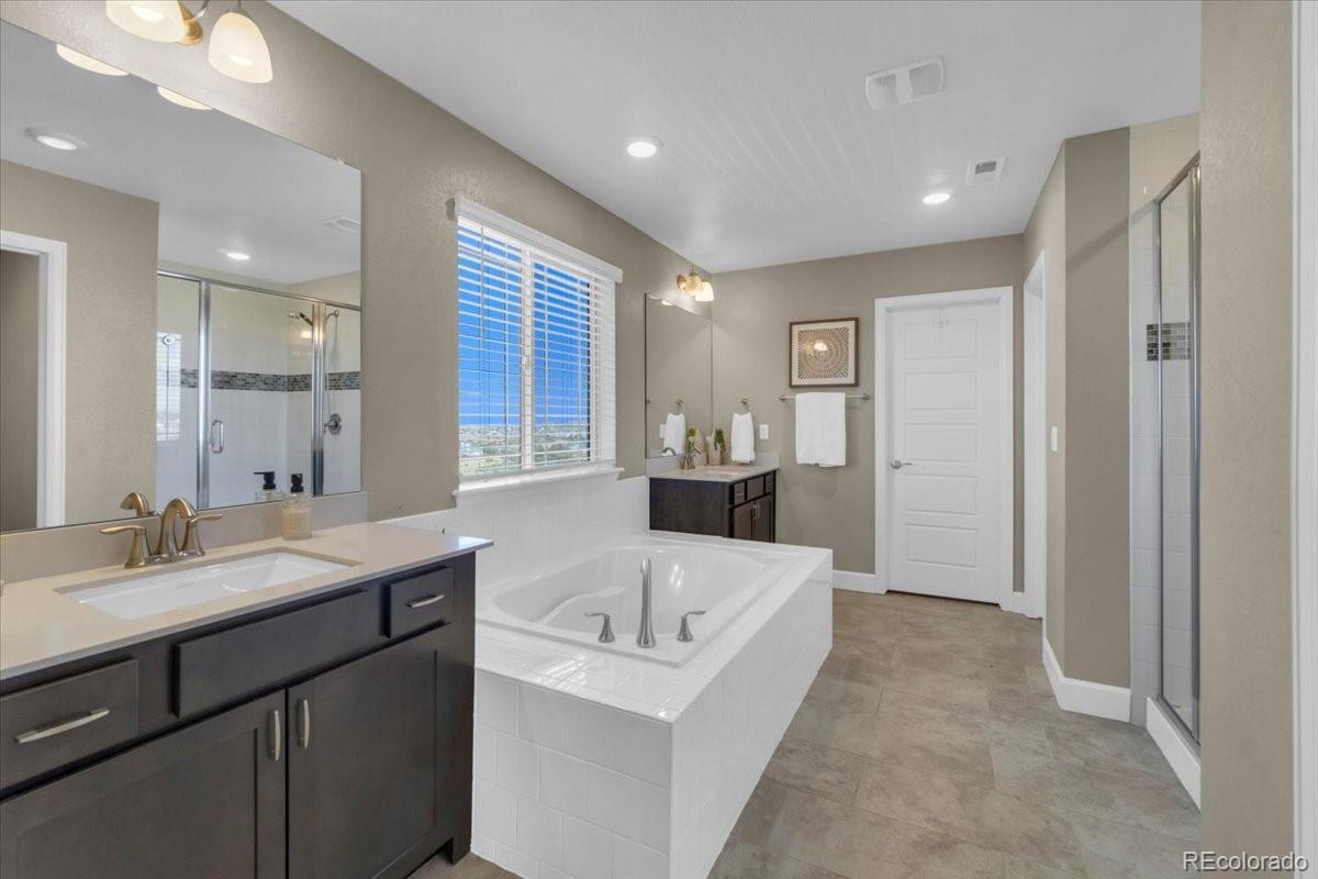 1721 Wingfeather Lane Castle Rock, CO 80108 - Photo 31 of 49 a bathroom with a bathtub and a sink