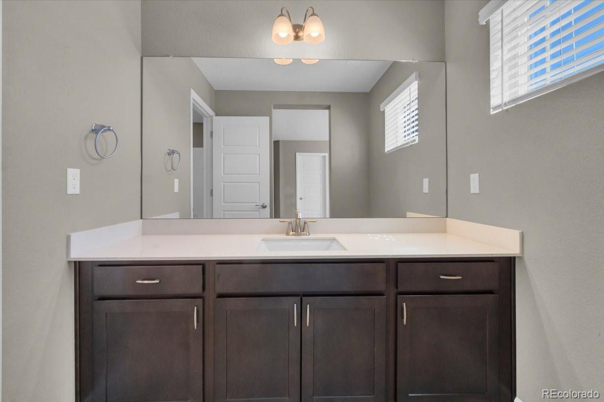 1721 Wingfeather Lane Castle Rock, CO 80108 - Photo 33 of 49 a bathroom with a sink and a mirror
