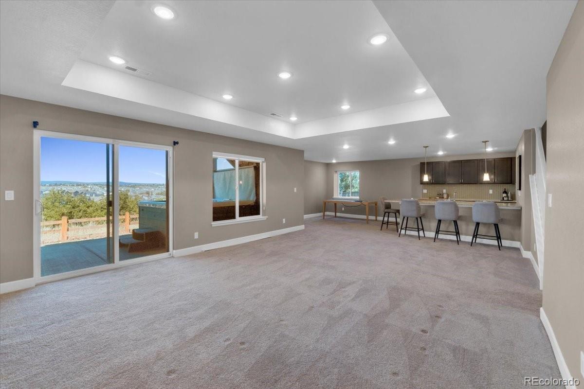 1721 Wingfeather Lane Castle Rock, CO 80108 - Photo 38 of 49 a view of an empty room with a large window and kitchen view